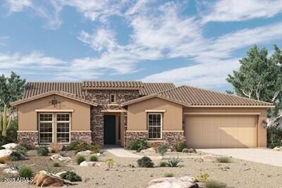 20209 W San Miguel Ave, Litchfield Park, AZ 85340 - view of front facade with an attached garage, concrete driveway, stone siding, and stucco siding
