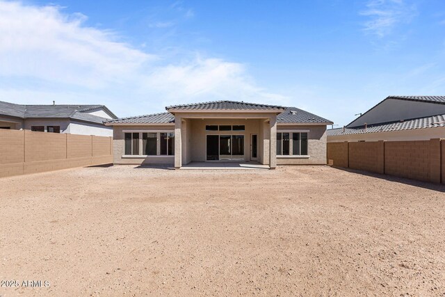 20209 W San Miguel Ave, Litchfield Park, AZ 85340 - back of house with a fenced backyard, a tile roof, a patio area, and stucco siding