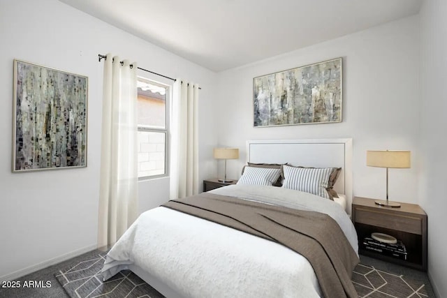 bedroom featuring carpet and baseboards