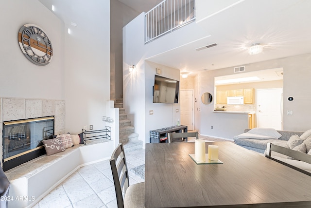 tiled dining area with a fireplace