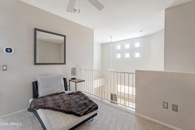 living area featuring ceiling fan and carpet floors