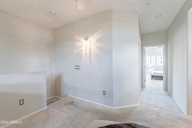 spare room with light colored carpet and ceiling fan