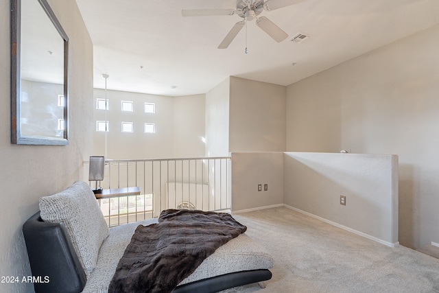 sitting room with ceiling fan and carpet floors