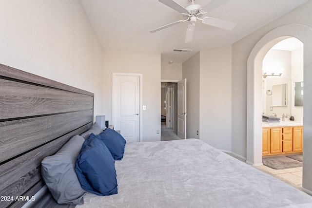 bedroom with ensuite bathroom, ceiling fan, and light tile patterned floors