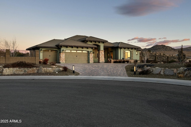 prairie-style house with a garage and a mountain view