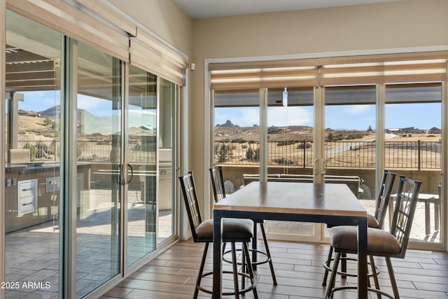 sunroom with plenty of natural light and a mountain view