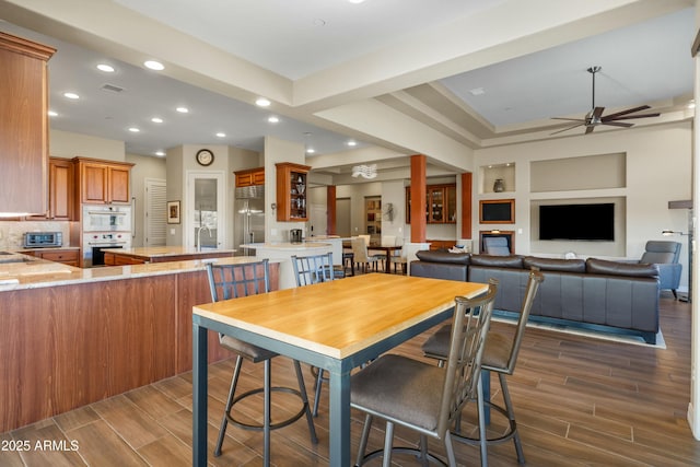 dining space featuring ceiling fan and sink