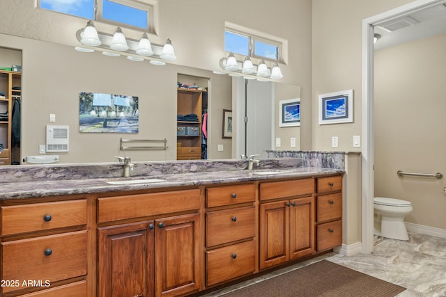 bathroom with toilet and vanity