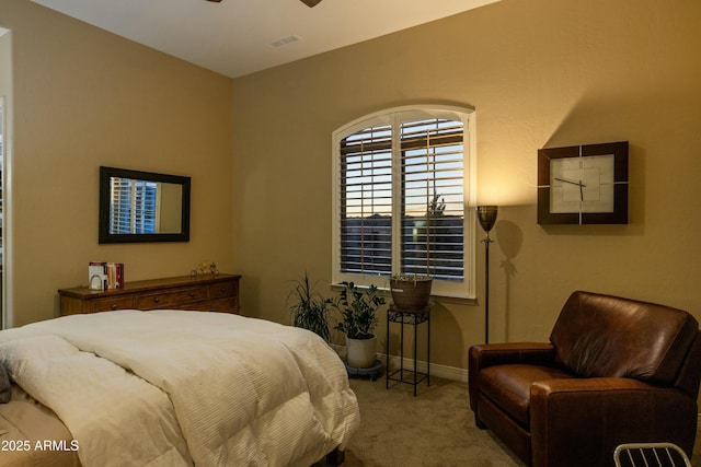 bedroom with ceiling fan and light colored carpet