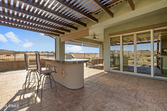 view of patio featuring an outdoor bar, ceiling fan, and a pergola