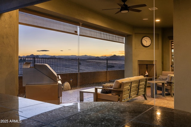 exterior space featuring exterior fireplace and ceiling fan