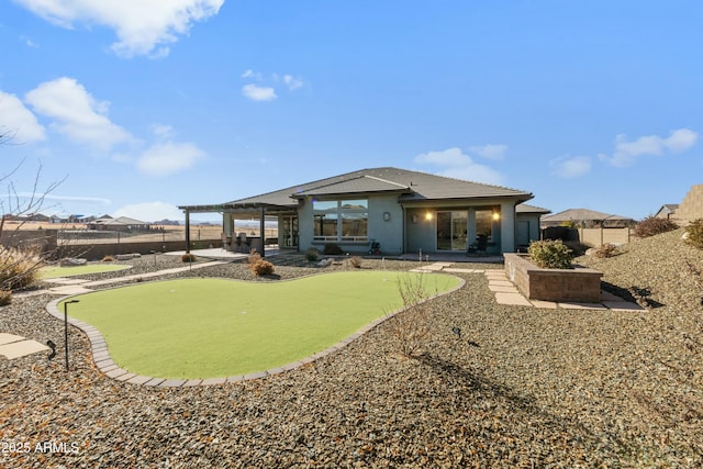 rear view of property featuring a pergola and a patio
