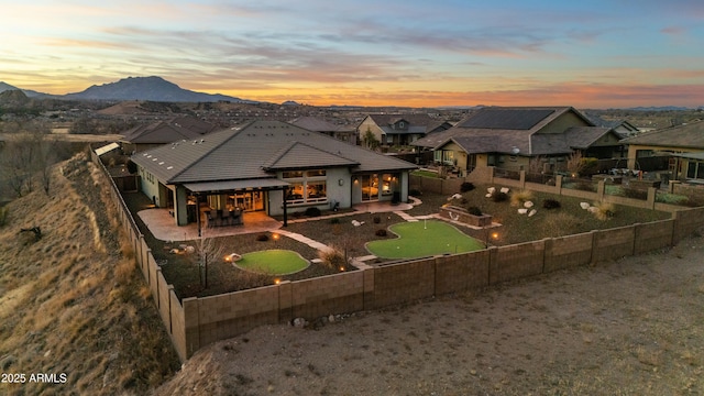 view of front facade with a mountain view and a patio area