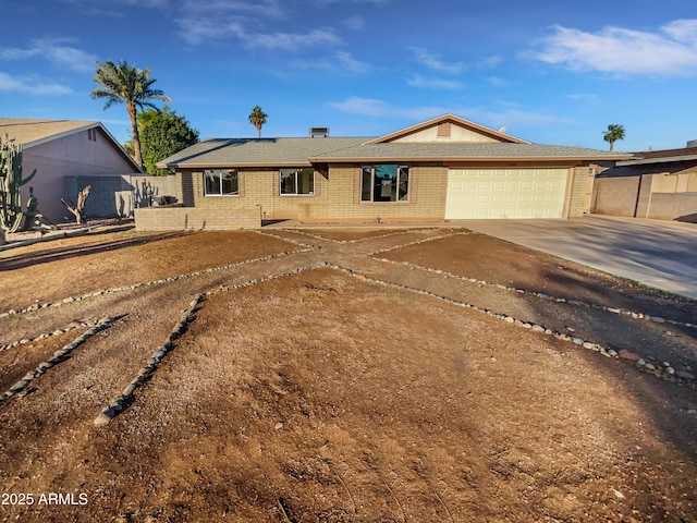 single story home with driveway, a garage, fence, and brick siding