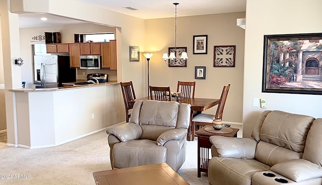 living area with light colored carpet and a chandelier