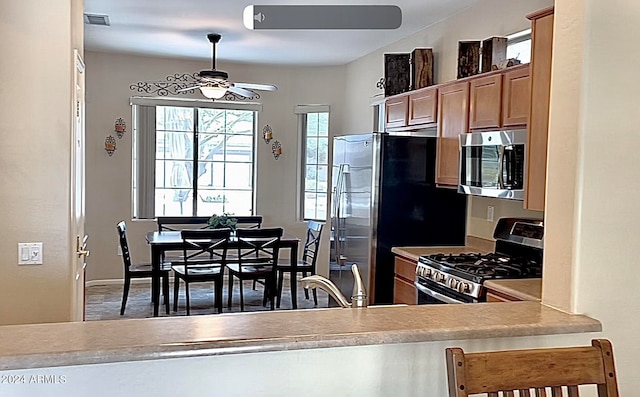 kitchen featuring ceiling fan and stainless steel appliances