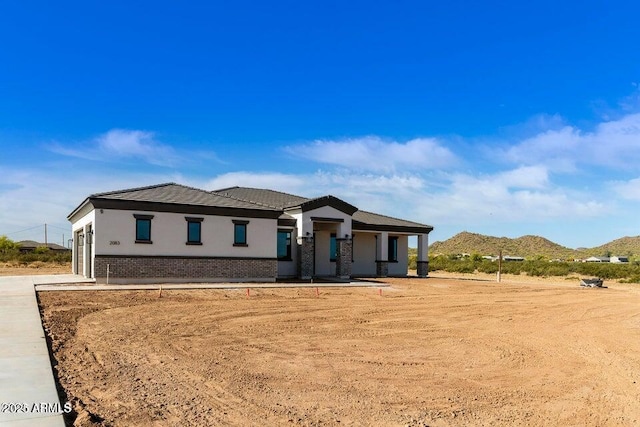 2083 W Lincoln Ct, San Tan Valley, AZ 85144 - view of front of property with brick siding, a mountain view, and stucco siding