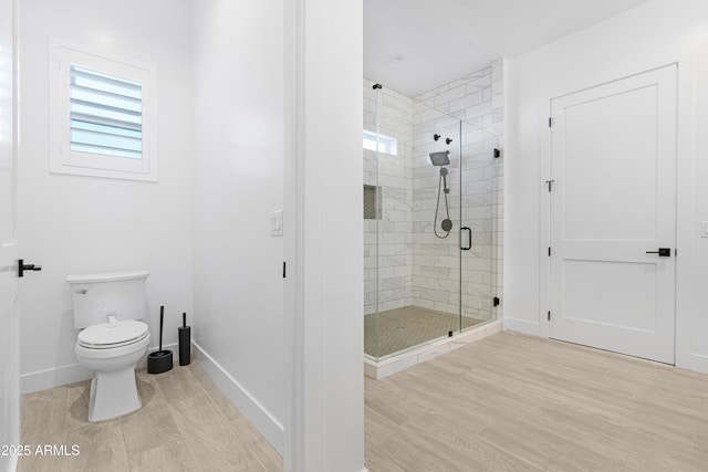 2083 W Lincoln Ct, San Tan Valley, AZ 85144 - bathroom with a stall shower, wood finished floors, baseboards, and toilet