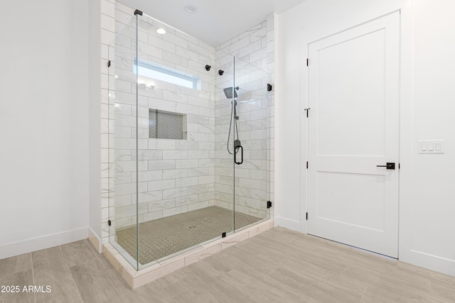2083 W Lincoln Ct, San Tan Valley, AZ 85144 - bathroom with a shower stall, wood finished floors, and baseboards