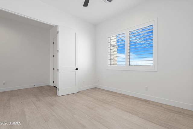 2083 W Lincoln Ct, San Tan Valley, AZ 85144 - empty room featuring light wood-style floors, a ceiling fan, and baseboards