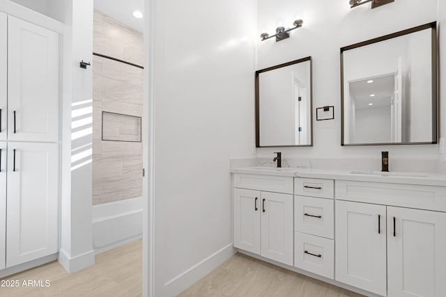 2083 W Lincoln Ct, San Tan Valley, AZ 85144 - bathroom featuring baseboards, double vanity, shower / tub combination, recessed lighting, and wood finished floors