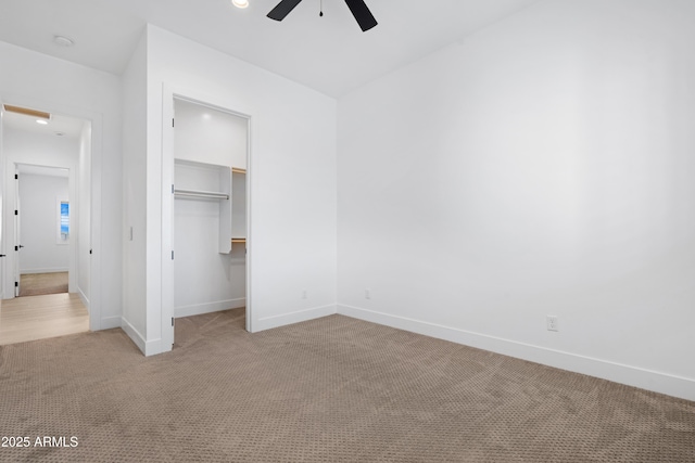 2083 W Lincoln Ct, San Tan Valley, AZ 85144 - unfurnished bedroom featuring light carpet, baseboards, a walk in closet, a closet, and a ceiling fan
