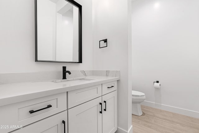 2083 W Lincoln Ct, San Tan Valley, AZ 85144 - bathroom with vanity, toilet, wood finished floors, and baseboards