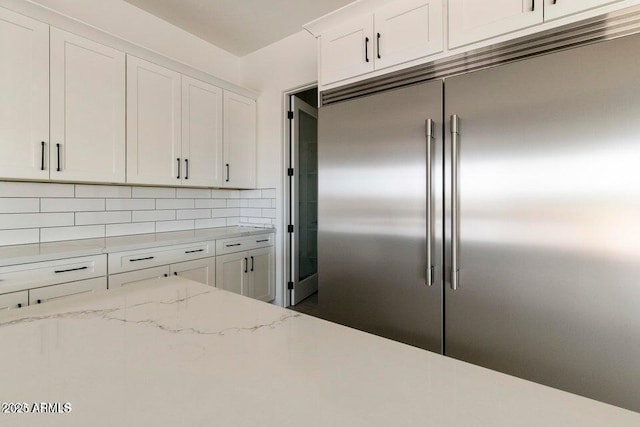 2083 W Lincoln Ct, San Tan Valley, AZ 85144 - kitchen featuring stainless steel built in refrigerator, white cabinetry, backsplash, and light stone countertops