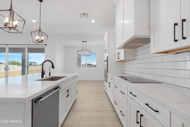 2083 W Lincoln Ct, San Tan Valley, AZ 85144 - kitchen featuring appliances with stainless steel finishes, a sink, a chandelier, backsplash, and an island with sink