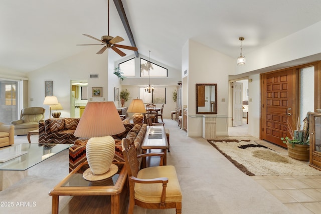 living room featuring visible vents, carpet flooring, high vaulted ceiling, beamed ceiling, and ceiling fan with notable chandelier