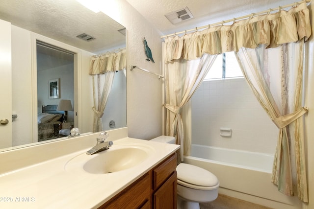 bathroom with toilet, visible vents, a textured ceiling, and vanity