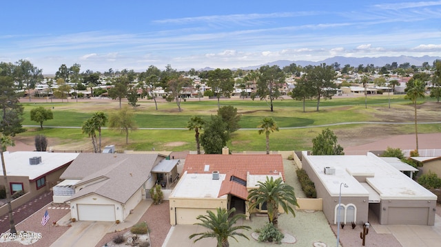 drone / aerial view featuring a residential view, view of golf course, and a mountain view