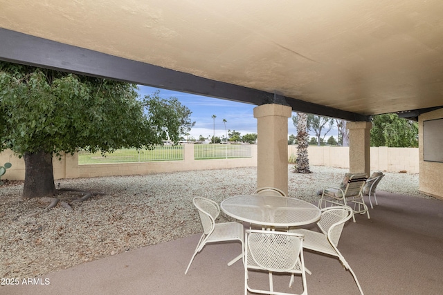 view of patio with outdoor dining area and a fenced backyard