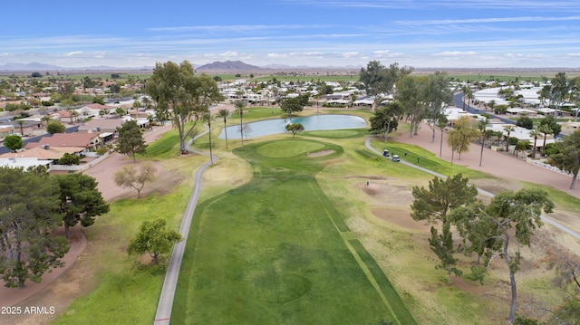 aerial view featuring a residential view, golf course view, and a water and mountain view