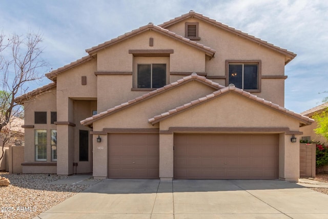 view of front of property with a tiled roof, driveway, and stucco siding