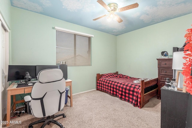 carpeted bedroom featuring baseboards and ceiling fan