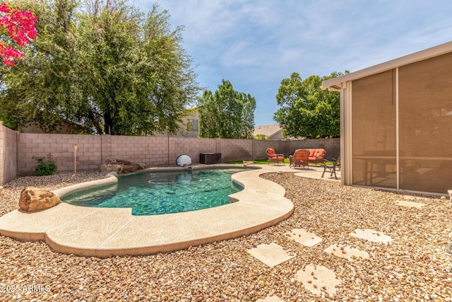view of swimming pool with a patio and a fenced backyard