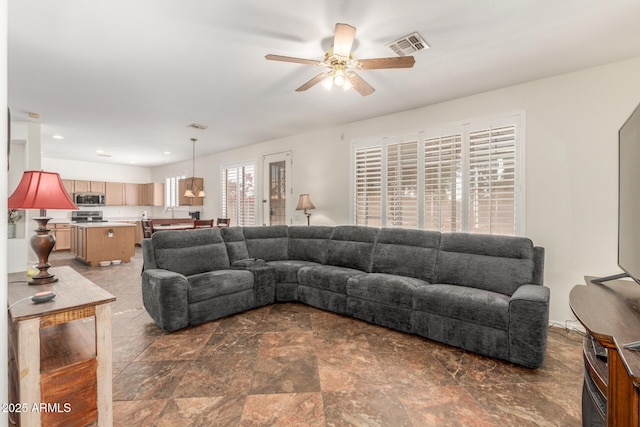living area featuring a ceiling fan, visible vents, and recessed lighting