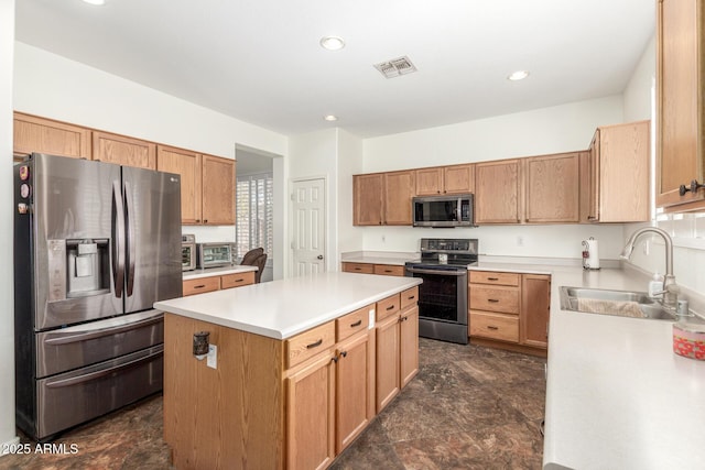 kitchen with light countertops, a kitchen island, visible vents, appliances with stainless steel finishes, and a sink