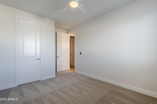 unfurnished bedroom with light carpet and ceiling fan