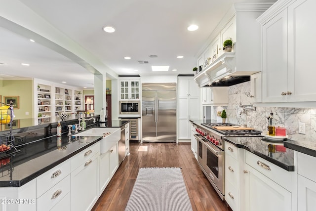 4710 N 33rd Pl, Phoenix, AZ 85018 - kitchen with built in appliances, white cabinetry, backsplash, and recessed lighting