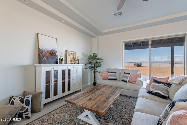 tiled living room featuring ceiling fan