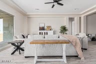 interior space featuring ceiling fan and crown molding