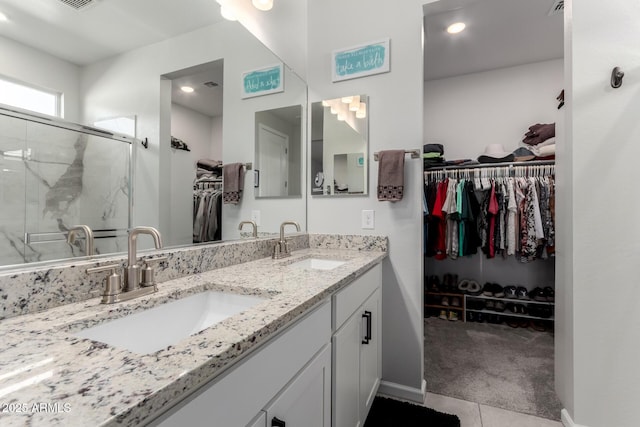 bathroom featuring vanity, tile patterned floors, and walk in shower