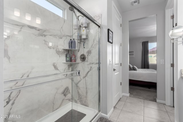 bathroom with tile patterned flooring and a shower with door