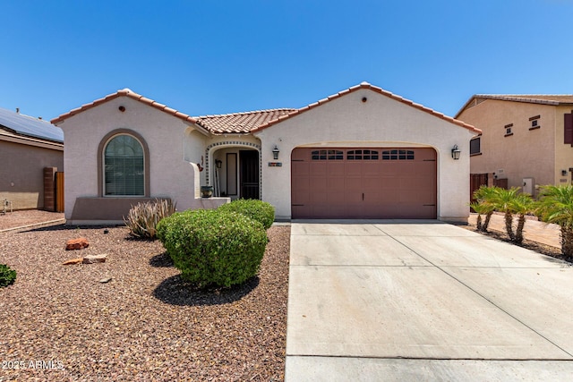 18669 W Vista Norte St, Goodyear, AZ 85338 - mediterranean / spanish house with a tiled roof, stucco siding, a garage, and concrete driveway