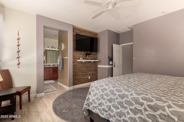 18669 W Vista Norte St, Goodyear, AZ 85338 - bedroom featuring light wood-style floors, a ceiling fan, and connected bathroom