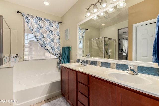 18669 W Vista Norte St, Goodyear, AZ 85338 - bathroom featuring a bath, a shower stall, double vanity, and tile patterned floors