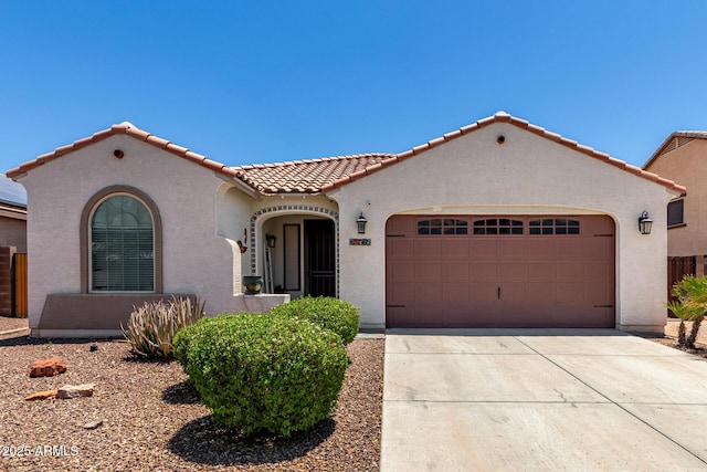 18669 W Vista Norte St, Goodyear, AZ 85338 - mediterranean / spanish house with stucco siding, a tile roof, an attached garage, and driveway