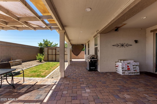 18669 W Vista Norte St, Goodyear, AZ 85338 - fenced backyard featuring a patio area, a storage shed, a grill, and a pergola